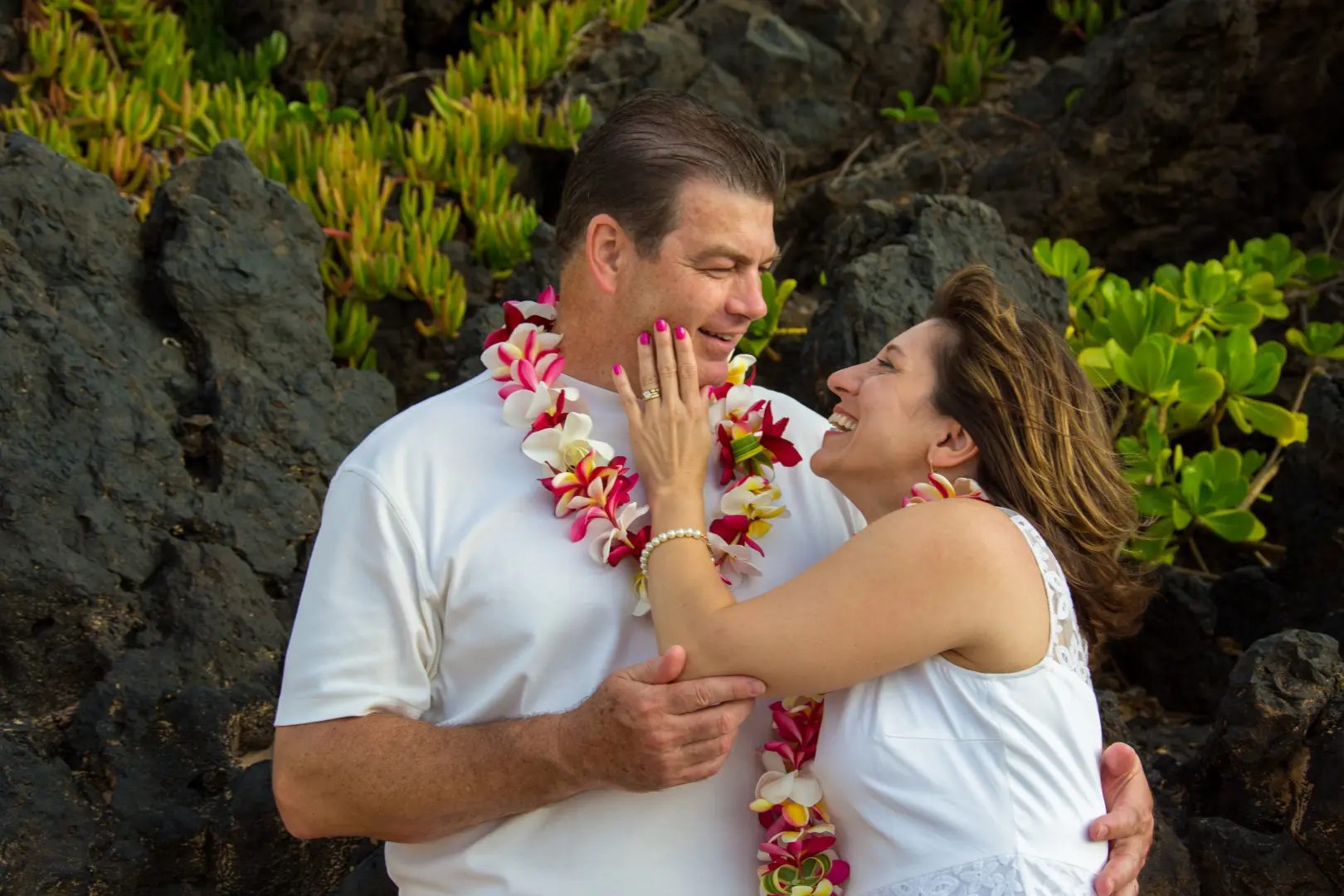 Couple posing for photograph in Hawaii beach wedding
