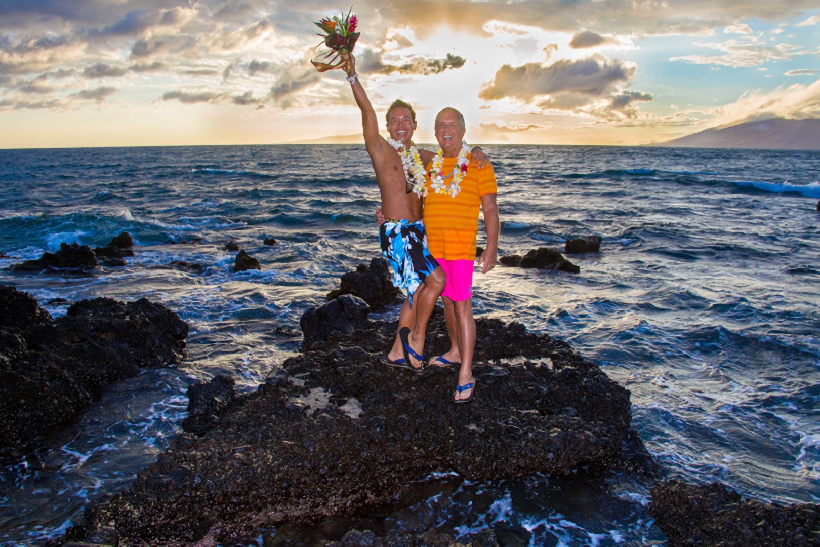 A couple of men posing for photographs at Maui Beach.