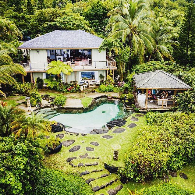 A beautiful house along with a pool and group of peoples
