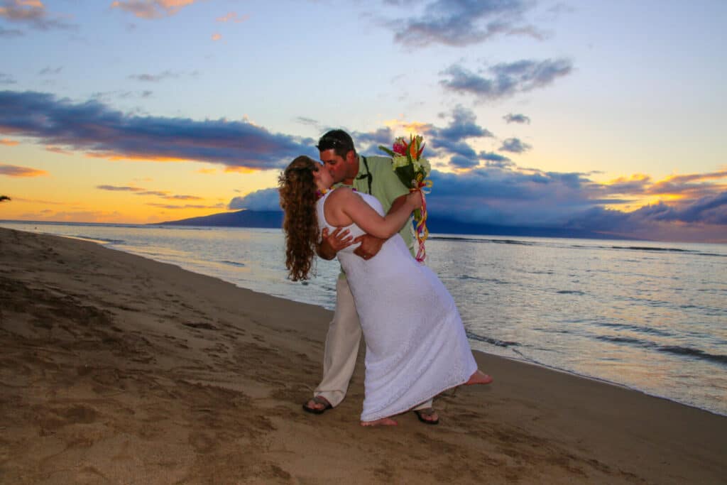 Romantic kiss at a Maui beach wedding