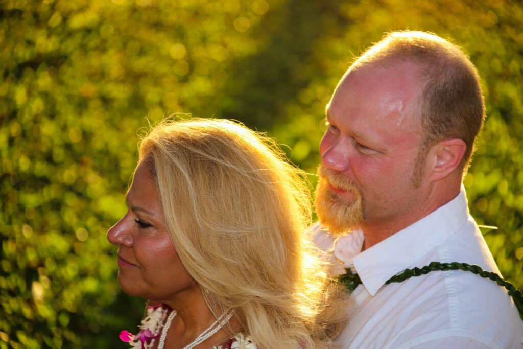 Husband and wife at a wedding ceremony in maui about to get maui'd