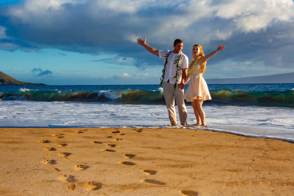 husband and wife walking on the beach