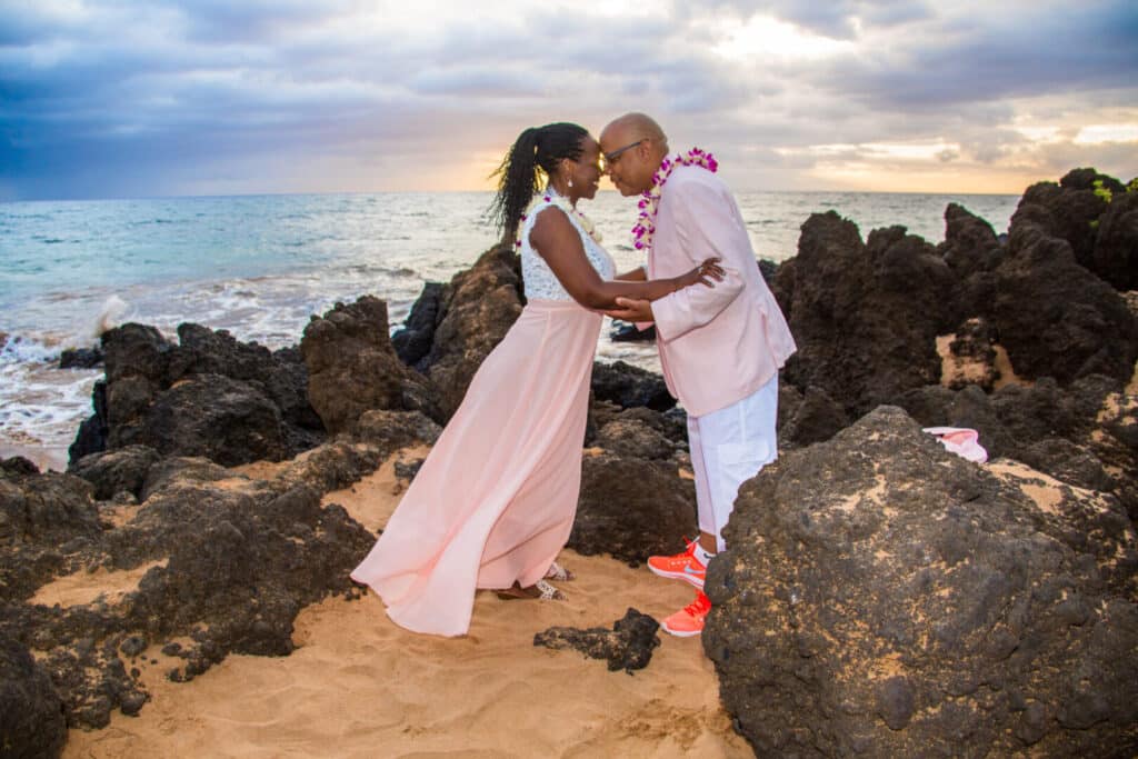 couple posing for a photo after getting married on a beach in Maui