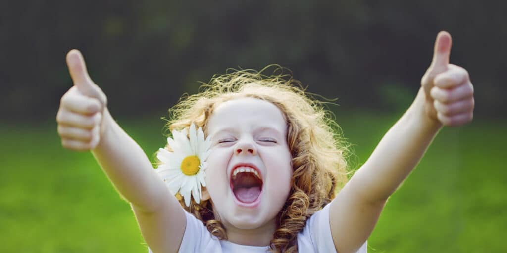 young girl being happy giving two thumbs up