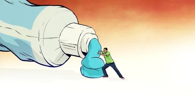 A man pushing a giant toothpaste blob from a huge tube.