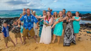 Family taking a photo at the beach in Maui