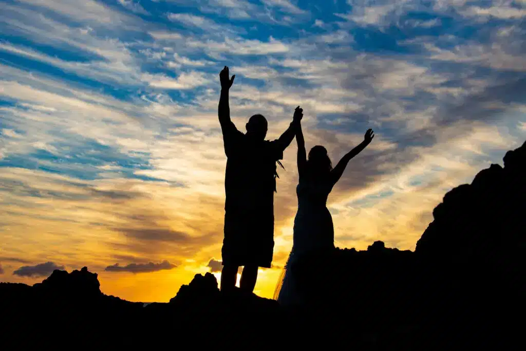 Couple celebrating a wedding in Maui at sunset.