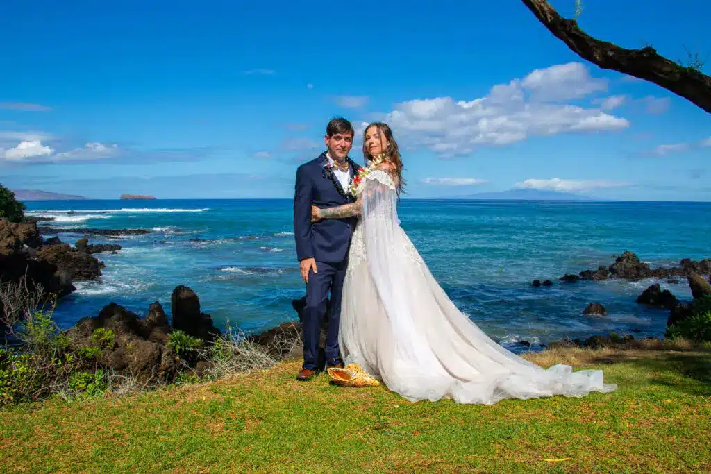 Husband and wife posing for their first photo after getting married in Maui