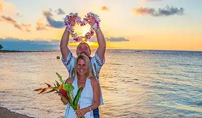 Husband and Wife posing for a romantic photo on a beach in Maui.