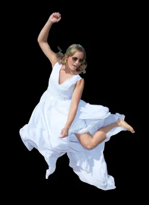 Bride in a wedding dress jumping with a black background