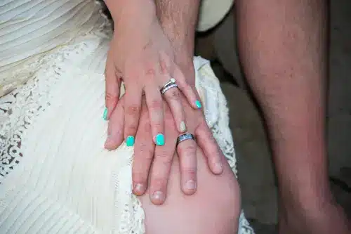 Close up of a couple wearing their wedding rings