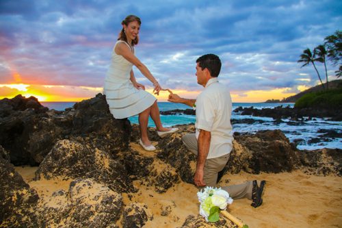 Maui beach wedding. Couple posing for a photo during a sunset wedding ceremony