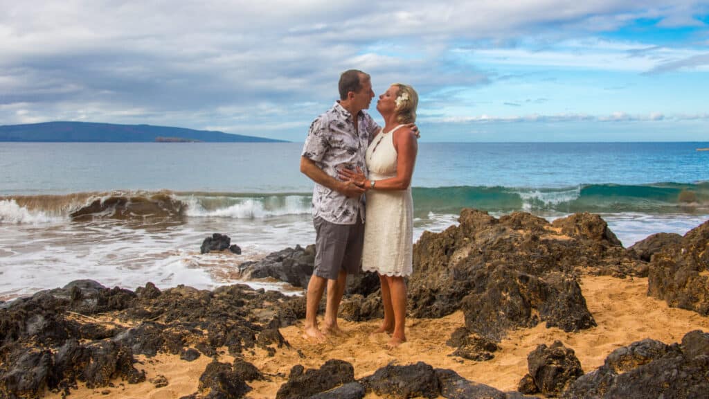 Husband and wife getting married on a beach in Maui HI