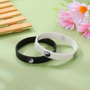 Two silicone rings, one black and one white, with small gems.