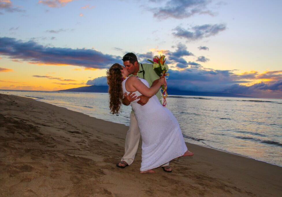 Romantic kiss at a Maui beach wedding