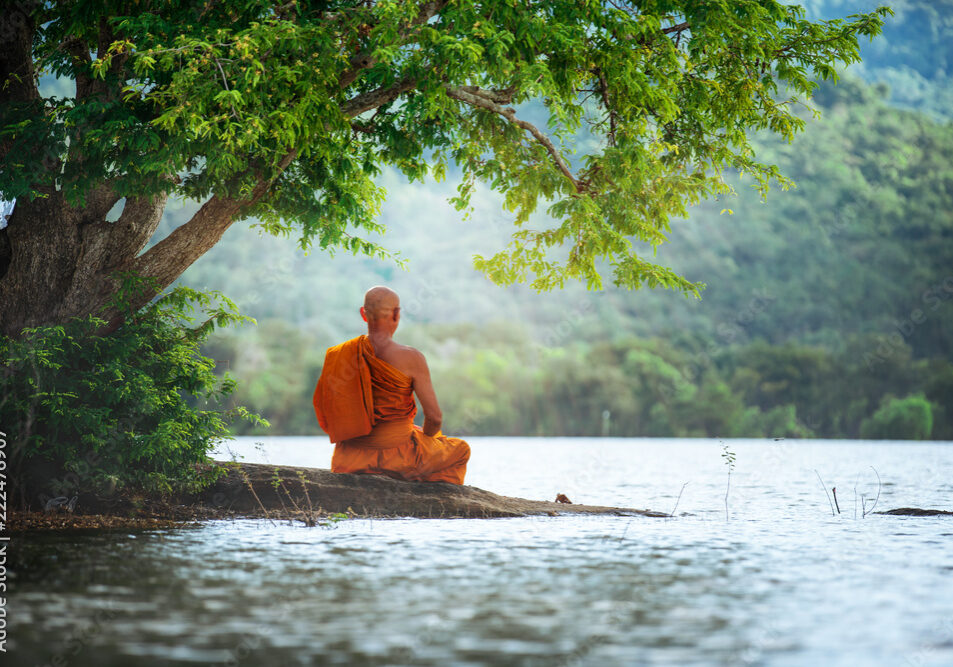 monk-meditating-by-river